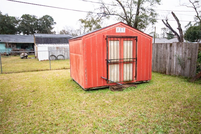 view of shed featuring fence