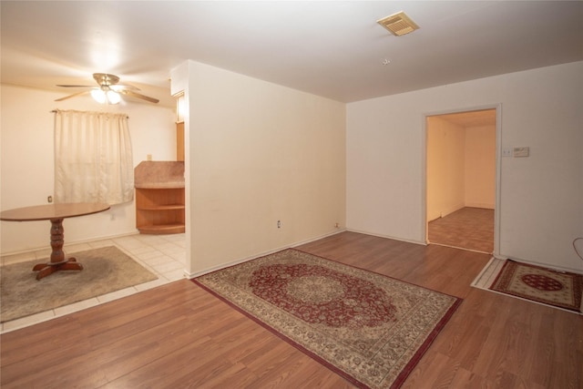 interior space featuring visible vents, wood finished floors, and a ceiling fan