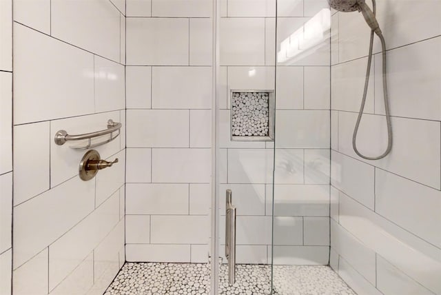 bathroom with a tile shower