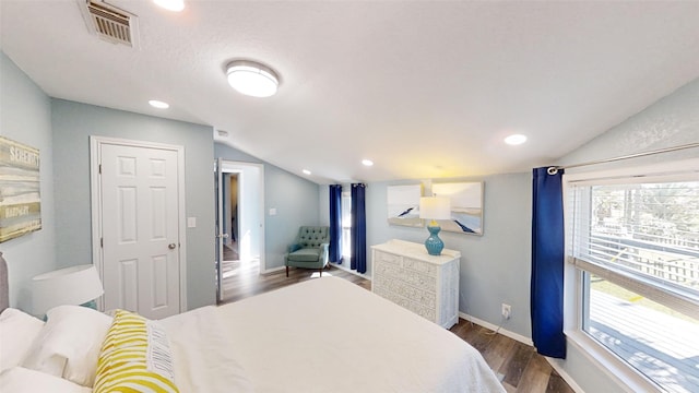 bedroom with lofted ceiling and dark hardwood / wood-style flooring