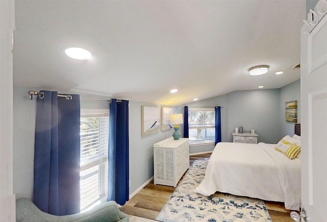 bedroom with lofted ceiling and light hardwood / wood-style flooring