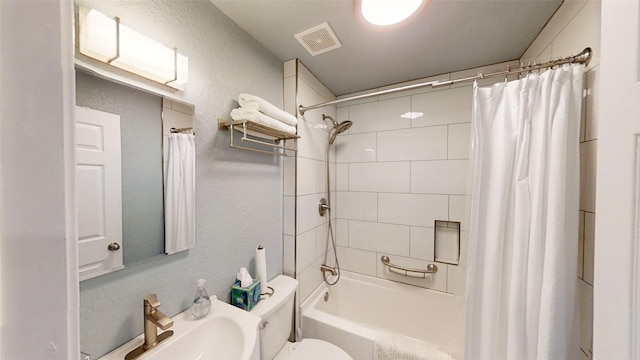 full bathroom with sink, shower / bath combo, and toilet