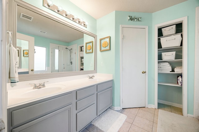 bathroom featuring vanity, walk in shower, and tile patterned floors