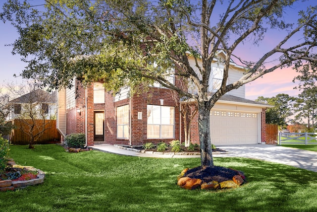 view of front of house featuring a yard and a garage