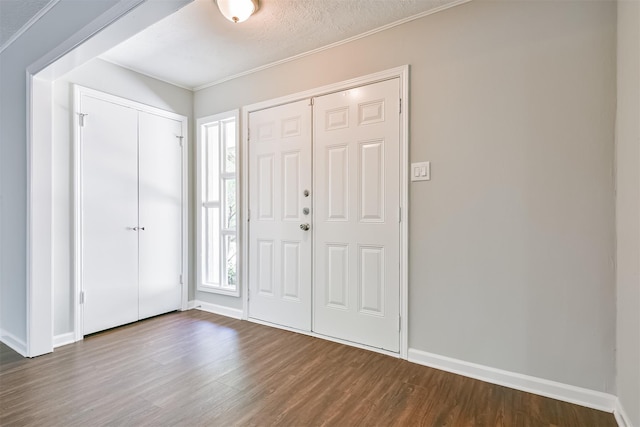 entryway with a textured ceiling and hardwood / wood-style flooring