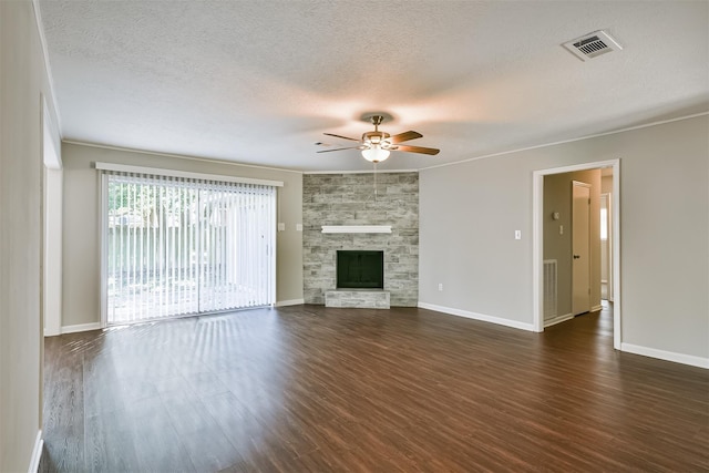 unfurnished living room with a textured ceiling, ornamental molding, dark hardwood / wood-style flooring, a fireplace, and ceiling fan