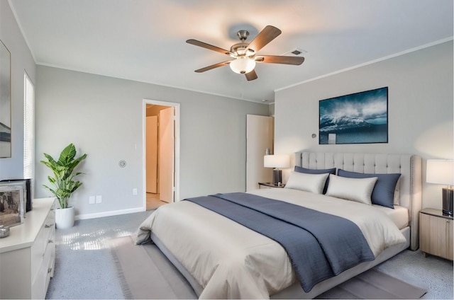 carpeted bedroom featuring ceiling fan and crown molding