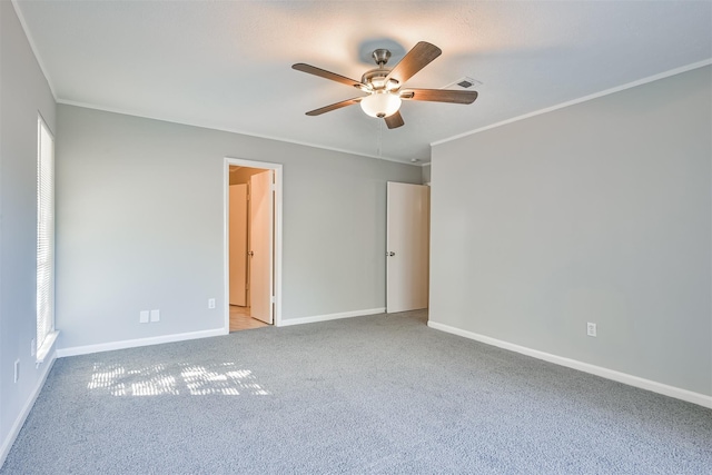 unfurnished room featuring ceiling fan, light colored carpet, and ornamental molding