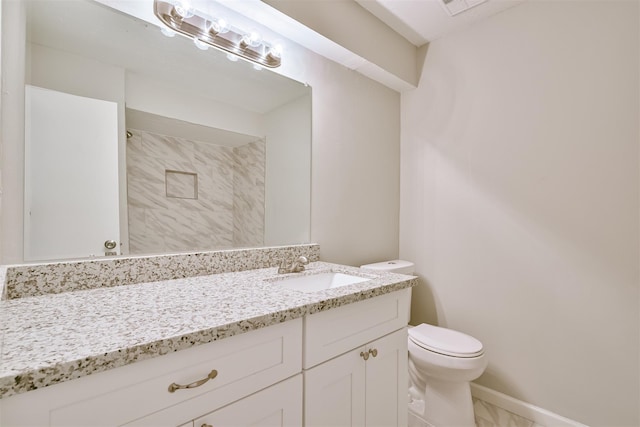 bathroom featuring toilet and vanity