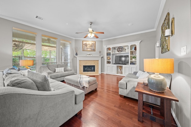 living room featuring ceiling fan, dark wood-type flooring, and crown molding