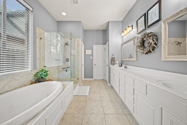 bathroom with a wealth of natural light, vanity, plus walk in shower, and tile patterned floors