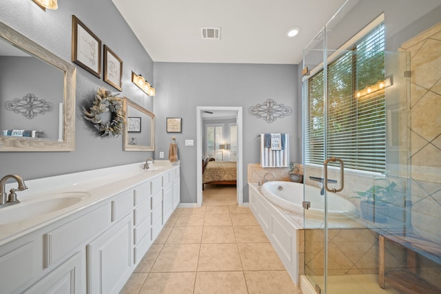 bathroom with vanity, tile patterned floors, and separate shower and tub