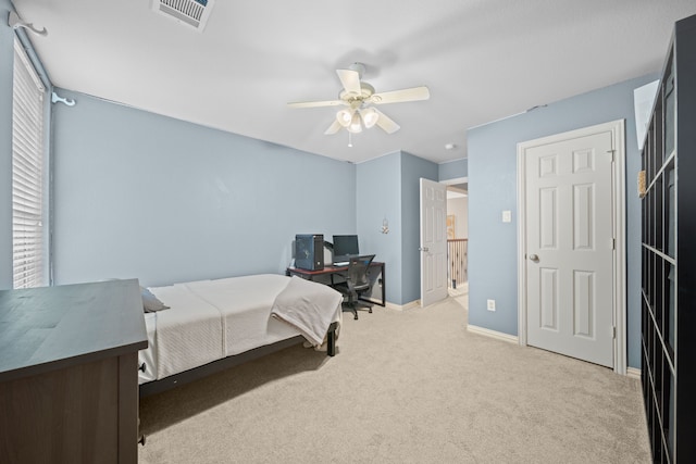 carpeted bedroom with multiple windows and ceiling fan