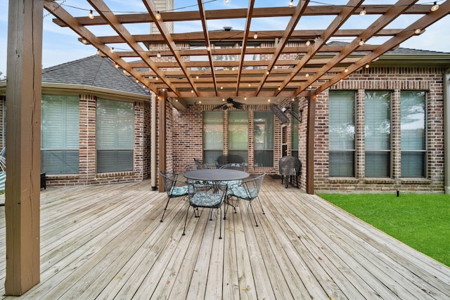 deck with ceiling fan and a pergola