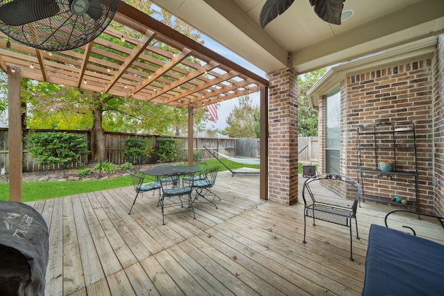 wooden deck featuring a grill, ceiling fan, and a pergola