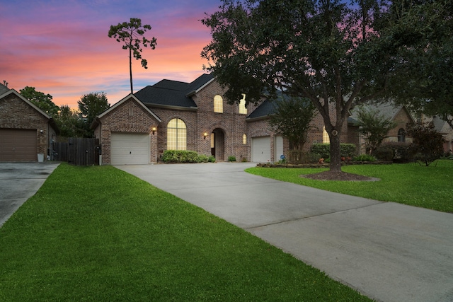 view of front of house with a yard and a garage