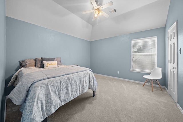 carpeted bedroom with lofted ceiling, ceiling fan, and a tray ceiling