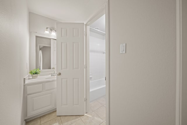 bathroom with washtub / shower combination, tile patterned floors, and vanity