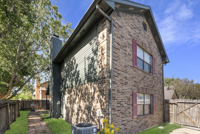 view of side of home with central AC unit