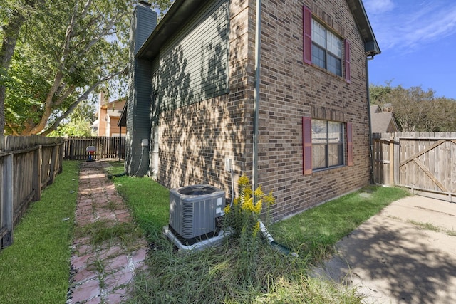 view of side of home with central AC unit