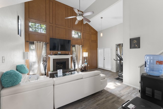 living room with ceiling fan, high vaulted ceiling, dark hardwood / wood-style floors, and a fireplace