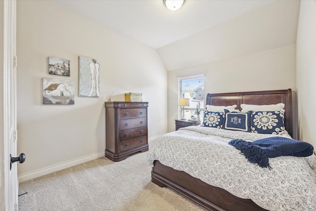 carpeted bedroom featuring lofted ceiling