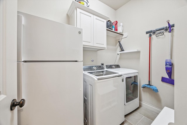 laundry room featuring light tile patterned flooring, independent washer and dryer, and cabinets