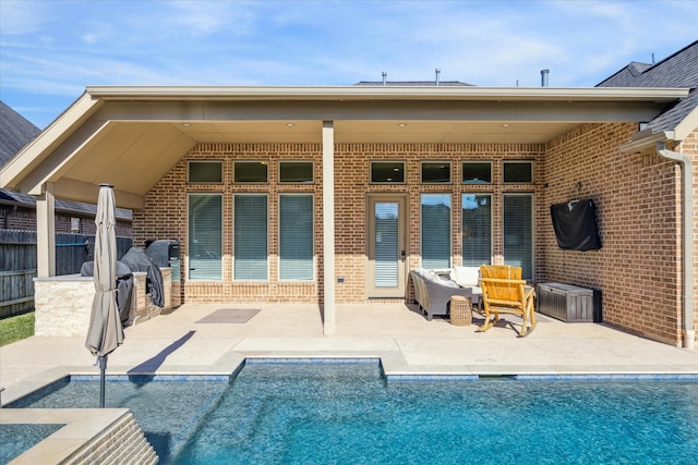 back of house featuring an outdoor living space and a patio area