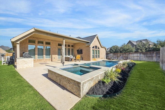 rear view of house featuring a swimming pool with hot tub, a patio, a yard, and area for grilling