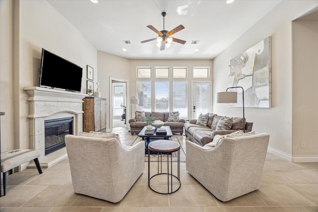 living room with ceiling fan and light tile patterned floors