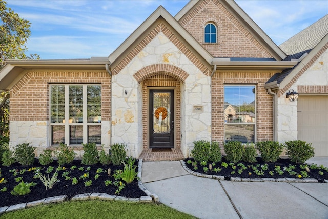 view of exterior entry with a garage