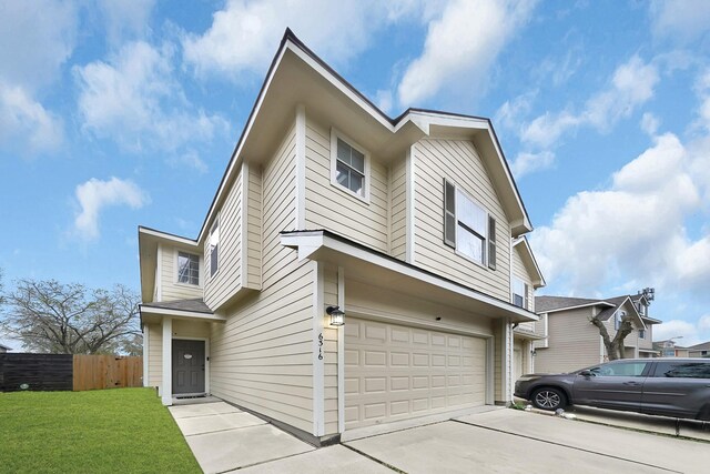 view of front of house featuring a front yard and a garage