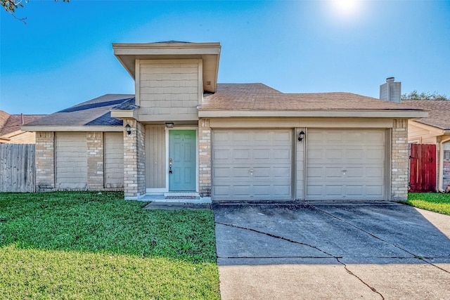 view of front of home with a front lawn and a garage