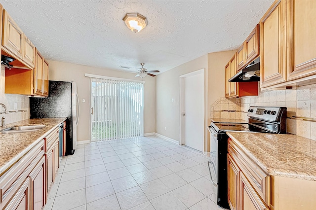 kitchen with sink, ceiling fan, light tile patterned floors, tasteful backsplash, and appliances with stainless steel finishes