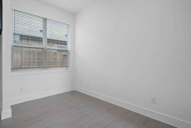 30551 Zoysia Point Ln, Fulshear, TX 77423 - spare room featuring baseboards and dark wood-style floors