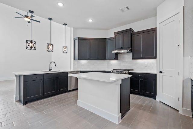 30551 Zoysia Point Ln, Fulshear, TX 77423 - kitchen featuring stainless steel dishwasher, a peninsula, light countertops, decorative backsplash, and recessed lighting