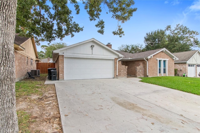 single story home featuring cooling unit, a front lawn, and a garage