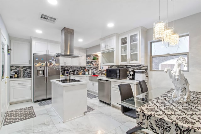 kitchen with a center island, white cabinetry, black appliances, and island exhaust hood