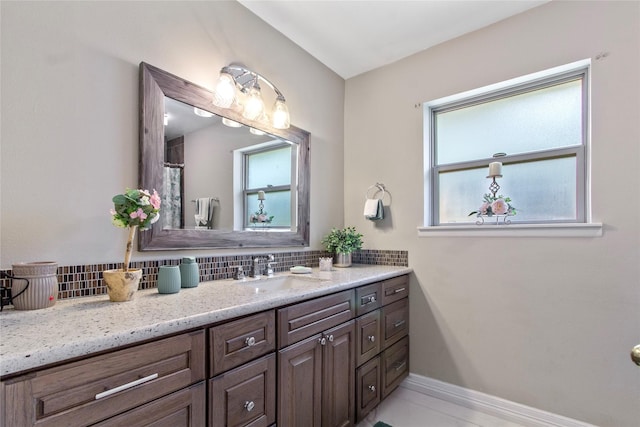 bathroom with vanity and decorative backsplash