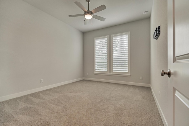 spare room with light colored carpet and ceiling fan