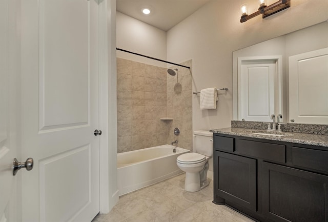 full bathroom with tiled shower / bath, vanity, and toilet