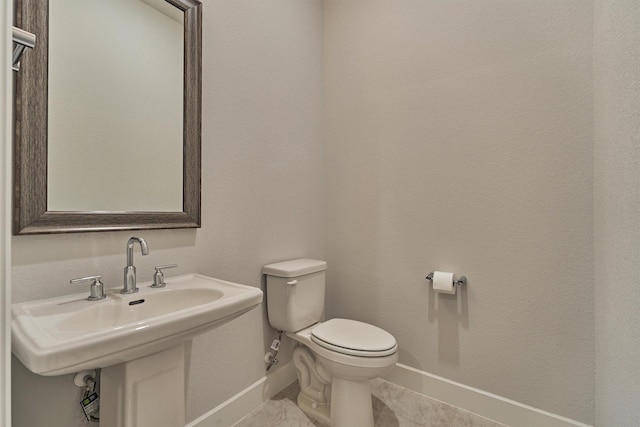 bathroom featuring tile patterned flooring, sink, and toilet