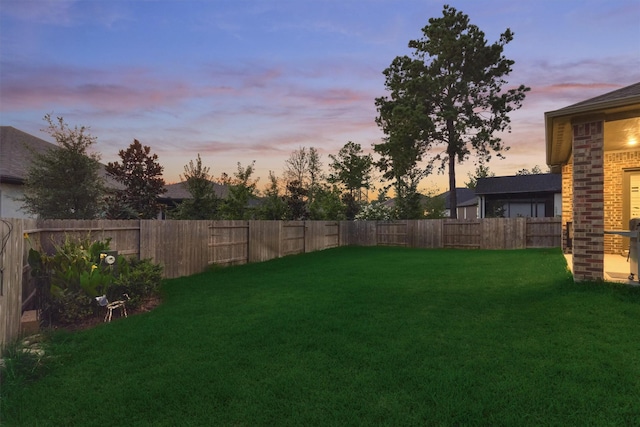 view of yard at dusk