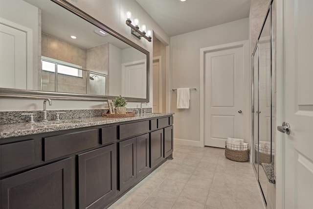 bathroom featuring vanity and a shower with shower door