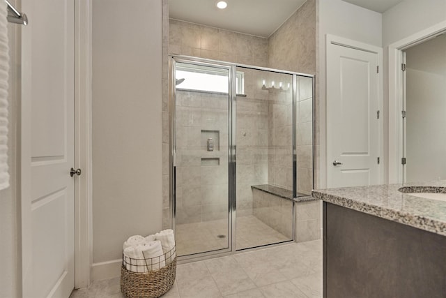 bathroom featuring vanity and a shower with door