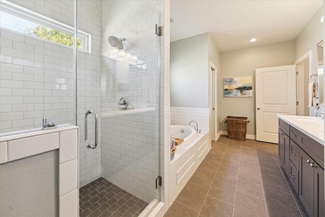 bathroom with shower with separate bathtub, vanity, and tile patterned floors