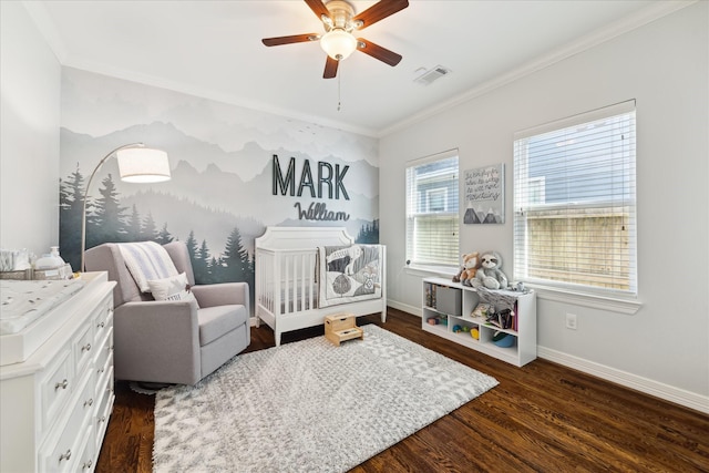 bedroom featuring a nursery area, ceiling fan, crown molding, and dark hardwood / wood-style floors