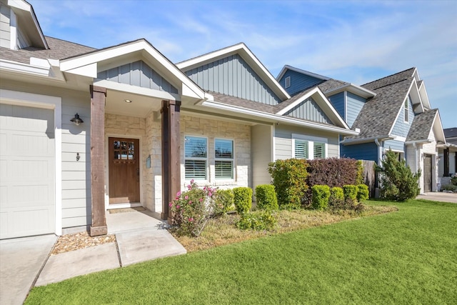 view of front of home with a front yard and a garage