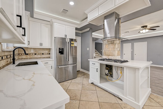 kitchen featuring white cabinetry, island range hood, and appliances with stainless steel finishes