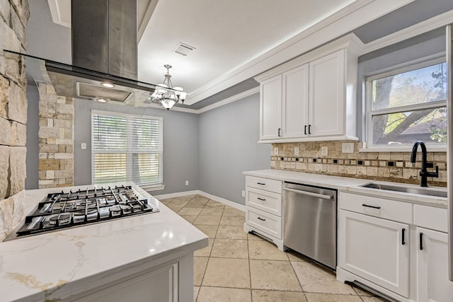 kitchen featuring plenty of natural light, white cabinets, appliances with stainless steel finishes, and sink